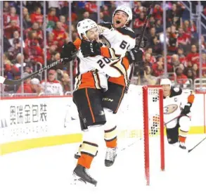  ?? (Getty Images/AFP) ?? Pontus Aberg (left) of the Anaheim Ducks celebrates his game-winning goal with teammate Kiefer Sherwood against the Washington Capitals during the third period in Washington.