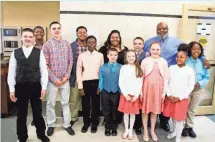  ?? MEG VOGEL, THE CINCINNATI ENQUIRER ?? Christina and Christophe­r Sanders pose with their family at the Hamilton County Probate Court, before their adoption of six children Thursday.