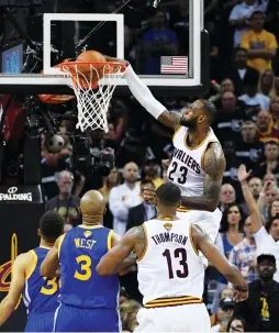  ?? (Reuters) ?? CLEVELAND CAVALIERS forward LeBron James dunks against the Golden State Warriors during the first half of Friday night’s Game 4 of the NBA Finals. With the Cavs facing eliminatio­n, James was dominant throughout the contest, racking up 31 points, 11...