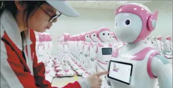  ?? REUTERS ?? A worker puts finishing touches to an iPal social robot, designed by AvatarMind, at an assembly plant in Suzhou, Jiangsu province.