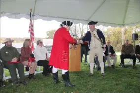  ?? LAUREN HALLIGAN - MEDIANEWS GROUP ?? British General John Burgoyne, portrayed by Bruce Venter, surrenders his sword to American General Horatio Gates, portrayed by Sean Kelleher, in a reenactmen­t during a Dedication Ceremony on Thursday at the Saratoga Surrender Site’s new memorial plaza.