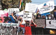  ?? ANI ?? Women holding posters protest against the hijab ban imposed in the few colleges in Karnataka, in Kolkata.