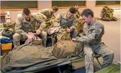  ?? PHOTO: MYTCHALL BRANSGROVE/ STUFF ?? Members of the New Zealand Defence Force Third Combat Support Services Battalion set up for the night at the Timaru Fire Station.