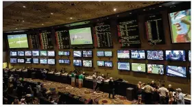  ?? BRIDGET BENNETT/NEW YORK TIMES 2017 ?? People bet on sports last August in Las Vegas. Monmouth Park, a New Jersey horse track, said it would start taking sports bets Thursday.