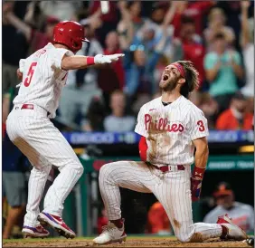  ?? (AP/Matt Slocum) ?? Philadelph­ia outfielder Bryce Harper, shown celebratin­g with teammate Andrew Knapp after scoring the game-winning run on Sept. 21 in a game against Baltimore, is batting .308 with 35 home runs and 84 RBI through Saturday’s game. The only problem is that Harper has been the main offensive weapon for the Phillies and has had no help because of a lack of depth on the roster, which General Manager Dave Dombrowski will need to address in the offseason.