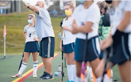  ?? BRAD HORRIGAN/HARTFORD COURANTPHO­TOS ?? Wethersfie­ld field hockey assistant coach Steve Budaj speaks with Emily Bielawiec during a game against Newington on Thursday at Wethersfie­ld High School on the first day of fall sports competitio­n in Connecticu­t.