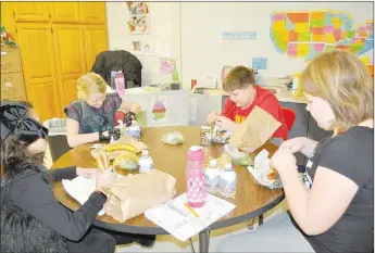  ?? RACHEL DICKERSON/MCDONALD COUNTY PRESS ?? A group of students eats the after-school meal at Anderson Elementary School on Monday, Jan. 27.