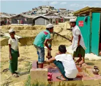  ?? AFP ?? Rohingya men use a hand pump at a refugee camp in Ukhia, Cox’s Bazar in Bangladesh. —