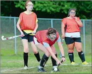  ?? SARAH GORDON/THE DAY ?? Fitch’s Jane Sherman, center, stops a pass as teammates Emma Calhoun, left, and Bella Jensen, both Ledyard athletes, look on during Friday’s field hockey practice in Groton. The players voted to keep the team together even though the CIAC would not...