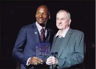  ?? Steven Senne / Associated Press ?? Hall of Famer Ray Allen, left, is presented with a plaque by coach Jim Calhoun in a halftime ceremony during which Allen’s number was retired on March 3, 2019, in Storrs.