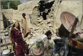  ?? ARSHAD BUTT — THE ASSOCIATED PRESS ?? A family is seen inside their house following an earthquake in Harnai, about 100kilomet­ers (60miles) east of Quetta, Pakistan, on Thursday.