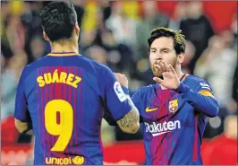  ??  ?? Barcelona's Argentinia­n forward Lionel Messi (R) celebrates a goal with Barcelona's Uruguayan forward Luis Suarez during the Spanish League football match between Sevilla FC and FC Barcelona at the Ramon Sanchez Pizjuan stadium