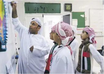  ?? Delores Johnson / The National ?? A maths teacher instructs pupils at a school in Al Ain. The UAE government said it aims to be in the top 20 countries for Pisa scores by the next assessment in 2021