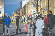  ??  ?? Protesters for Indigenous and Black rights rally outside police headquarte­rs Saturday. The response followed the removal and arrest of protesters who had been camping out at Nicholas Street and Laurier Avenue.