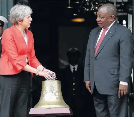  ?? Picture: REUTERS/MIKE HUTCHINGS ?? TRADE TALKS: Britain's Prime Minister Theresa May and President Cyril Ramaphosa take part in the ceremony to hand over the bell of the SS Mendi in Cape Town on Tuesday.