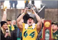  ?? Michael Ainsworth / Associated Press ?? North Dakota State fullback Hunter Luepke celebrates with his most valuable player award after beating Montana State in the FCS championsh­ip game in Frisco, Texas.