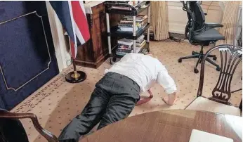  ??  ?? BRITAIN’S Prime Minister Boris Johnson gets parallel with the floor to prove he has recovered from Covid-19.