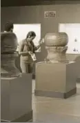  ?? ARUN SHARMA/HT ?? A visitor looks at an artefact at the Harappan Civilisati­on Gallery, National Museum, Delhi