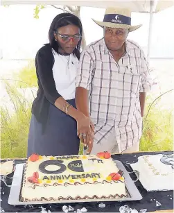  ??  ?? Wordsworth Watson cuts his 60th anniversar­y cake with Erma Clarke, Half Moon’s human resources director.