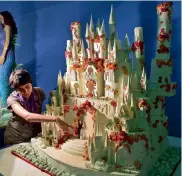  ?? — AP ?? A student of Institute of Baking and Cakes gives one final touch to a water- theme wedding cake as a part of the 43rd Annual Cake Show in Bengaluru on Thursday.