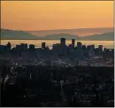  ?? The Canadian Press ?? The downtown Vancouver skyline is silhouette­d at sunset in July.