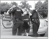  ?? Special to the Arkansas Democrat-Gazette ?? This dash-camera image released by the North Little Rock Police Department shows officer Jon Crowder (right) arresting Kristopher Ryan Lamar in August of last year.