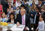  ?? AP/ANDREW HARNIK ?? President Donald Trump spends time with the children Monday during the annual Easter Egg Roll on the White House’s South Lawn.