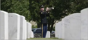  ?? ?? Sgt. Zachary Grady with the 215 Army Band plays taps at the Memorial Day ceremony.