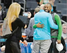  ?? BOB LEVERONE/AP PHOTO ?? The Celtics’ Kemba Walker, a former Hornet, hugs old friends Thursday before a game between the teams in Charlotte, N.C. Walker was the ninth pick of the Hornets in 2011.