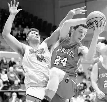  ?? KYLE TELECHAN/POST-TRIBUNE PHOTOS ?? Munster’s Luka Balac (24) grabs a rebound from La Porte’s Grant Ott-Large during their game Friday.