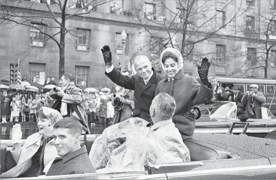  ?? Associated Press ?? THE RIGHT STUFF — AND MORE John Glenn and his wife, Annie, wave during a rainy parade in Washington, D.C., honoring the celebrated astronaut after his return from space in February 1962. Also in the car are Vice President Lyndon Johnson and Glenn’s...