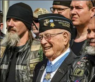  ?? ASSOCIATED PRESS ?? Hershel "Woody" Williams (center) the sole surviving US Marine to be awarded the Medal of Honor during World War II, poses with fellow Marines at the Charles E. Shelton Freedom Memorial at Smothers Park, April 6, 2019, in Owensboro, Ky.