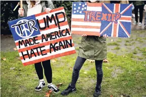  ?? FILE ?? In this February 4, 2017 photo, demonstrat­ors hold placards as they take part in a protest outside the US embassy in London, against US President Donald Trump