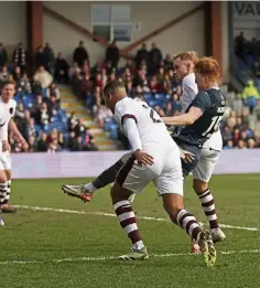  ?? ?? Simon Murray nips in to score against Hearts.