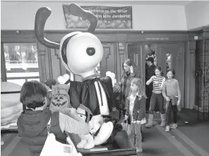  ?? Associated Press ?? A statue of Snoopy welcomes families Sunday to Snoopy’s Home Ice in Santa Rosa, Calif. The annual hockey tournament for 7- and 8-year-olds was held as scheduled Sunday in the rink financed by Peanuts creator Charles Schultz, who was a Santa Rosa...