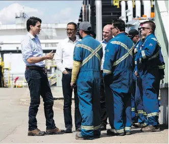  ?? PHOTOS: DAVID BLOOM ?? Prime Minister Justin Trudeau, Infrastruc­ture Minister Amarjeeet Sohi and Edmonton Centre Liberal MP Randy Boissonnau­lt visit Tuesday with workers at the Kinder Morgan Edmonton Terminal.