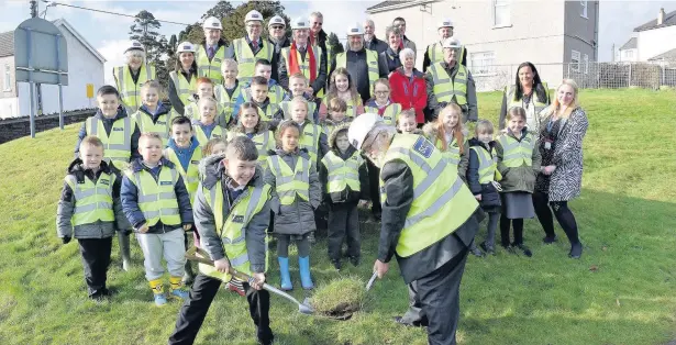  ??  ?? School pupils, teachers, governors, Bridgend County Borough Council cabinet members, Ogmore AM Huw Irranca-Davies and contractor­s Andrew Scott Ltd came together for last week’s ground-breaking ceremony on the site of two new schools in Betws, where the...