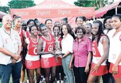  ?? RICARDO MAKYN ?? From left: Digicel’s Mark Martin, sports sponsorshi­p executive, looks on as Sandra Ledgister, sponsorshi­p executive, presents the trophy to members of The School senior team who defeated Holmwood in the AllIsland final at the Manchester High School...