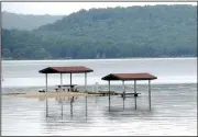  ?? NWA Democrat-Gazette/FLIP PUTTHOFF ?? A pair of campsites are surrounded Wednesday by Beaver Lake at Rocky Branch park. The level of Beaver Lake remains high after heavy rain during spring.