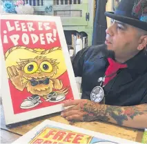  ?? PHOTO / AP ?? Illustrato­r Moises Salcedo, who goes by the name El Moises, shows a panel of characters for the bilingual children’s book Owl in a Straw Hat in his hometown of Albuquerqu­e.