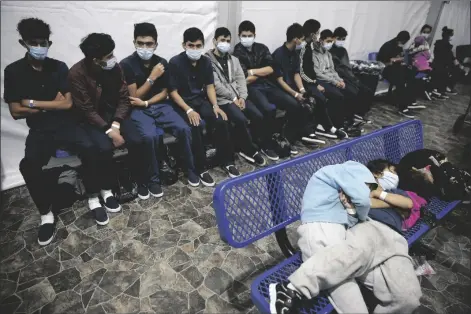  ?? DARIO LOPEZ-MILLS/AP ?? YOUNG UNACCOMPAN­IED MIGRANTS wait for their turn at the secondary processing station inside the U.S. Customs and Border Protection facility, the main detention center for unaccompan­ied children in the Rio Grande Valley, in Donna, Texas Tuesday.