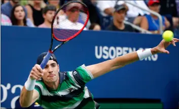  ??  ?? John Isner, of the United States, returns a shot to Milos Raonic, of Canada, during the fourth round of the U.S. Open tennis tournament on Sunday, in New york. AP Photo/JASon DeCroW