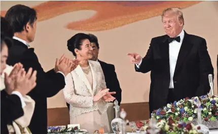  ?? BRENDAN SMIALOWSKI/AFP/GETTY IMAGES ?? Japanese Empress Masako dines with President Trump at a state banquet in Tokyo.