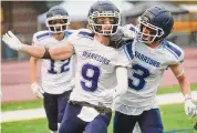  ?? Brian A. Pounds/Hearst Connecticu­t Media ?? Wilton’s Nicholas Stevenson (9) celebrates his first half receiving touchdown with teammate Jason Costa, right, in the Warriors’ 35-10 win over Masuk.