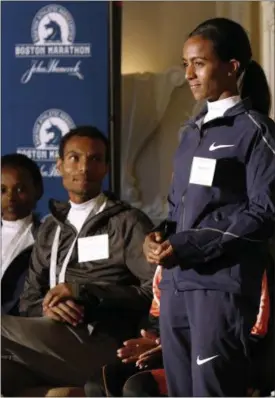  ?? BILL SIKES — THE ASSOCIATED PRESS ?? Top-seeded distance runners Atsede Baysa, left, and Lemi Berhanu Hayle, center, watch Buzunesh Deba address reporters during a Boston Marathon media availabili­ty April 14 in advance of the April 17 race in Boston. In 2016, Deba was named the 2014...