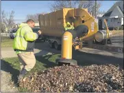  ?? RICHARD PAYERCHIN — THE MORNING JOURNAL ?? Lorain city workers use one of the city’s two Spartan Leaf Pro Plus leaf collection trailers to suck up leaves on Lexington Avenue on Nov. 26, 2019. The city crews will begin leaf collection on Nov. 2and continue at least through Dec. 1, depending on weather.