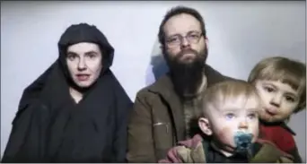  ?? (TALIBAN MEDIA VIA AP ?? In this image from video released by Taliban Media in December 2016, Caitlan Coleman talks in the video while her Canadian husband Joshua Boyle holds their two children. U.S. officials said Pakistan secured the release of Coleman of Stewartsto­wn, Pa.,...