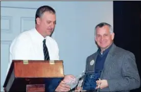  ?? CONTRIBUTE­D PHOTO ?? Shawn Chastain, left, operations manager of the City of Calhoun Recycling Center, presents a plaque to Johnathan Purser of Chick-fil-A.