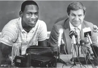  ?? AP ?? North Carolina coach Dean Smith and Michael Jordan hold a 1984 news conference announcing Jordan was entering the NBA draft.