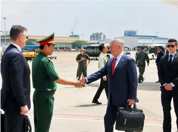  ??  ?? Mattis (right) shakes hands with an official upon his arrival in Ho Chi Minh City. — AFP photo